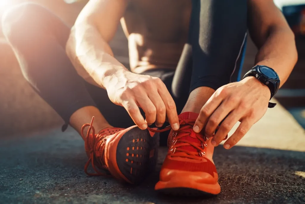 a man is tying his shoes.